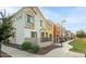 Street view of colorful townhomes featuring small gated courtyards and desert landscaping at 1950 N Center St # 111, Mesa, AZ 85201