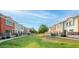 A row of townhomes facing a lush green common area on a sunny day at 1950 N Center St # 111, Mesa, AZ 85201