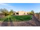 Expansive backyard with lush lawn, gravel border, desert landscaping, and view of the home's rear facade at 20212 E Appaloosa Dr, Queen Creek, AZ 85142