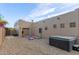 View of the backyard featuring a hot tub, car lift, and desert landscaping at 20212 E Appaloosa Dr, Queen Creek, AZ 85142