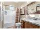 Bathroom with a shower-tub combination, granite countertop, and wooden cabinetry at 20212 E Appaloosa Dr, Queen Creek, AZ 85142