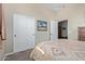 Bedroom featuring a queen-size bed, closet, and view into adjacent room at 20212 E Appaloosa Dr, Queen Creek, AZ 85142