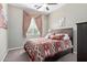 Bedroom featuring a ceiling fan, patterned bedding, and natural light from a large window at 20212 E Appaloosa Dr, Queen Creek, AZ 85142