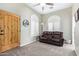 Bonus room featuring a leather loveseat, a wooden door, carpet flooring, and shuttered windows at 20212 E Appaloosa Dr, Queen Creek, AZ 85142