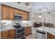 Modern kitchen with stainless steel appliances, granite counters, and wood cabinets at 20212 E Appaloosa Dr, Queen Creek, AZ 85142