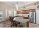 Spacious kitchen with granite countertops, a stainless steel refrigerator, and wooden cabinets at 20212 E Appaloosa Dr, Queen Creek, AZ 85142