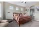 Well-lit main bedroom with a wood bed frame, ceiling fan, and neutral decor at 20212 E Appaloosa Dr, Queen Creek, AZ 85142