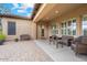 Relaxing covered patio showcasing comfortable seating, a dining table, and neutral colors, perfect for outdoor entertaining and lounging at 2025 W Calle Del Sol --, Phoenix, AZ 85085