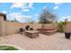 Outdoor living space features a stone fire pit and hot tub, with cozy seating on a paver patio surrounded by desert landscaping at 2025 W Calle Del Sol --, Phoenix, AZ 85085