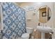 Full bathroom with a pedestal sink, floral shower curtain, and a 'Relax' wall sign at 2025 W Calle Del Sol --, Phoenix, AZ 85085