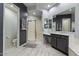 Stylish bathroom with a glass-enclosed shower, dual vanities, and marble countertops at 2025 W Calle Del Sol --, Phoenix, AZ 85085