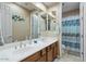 Well-lit bathroom featuring dual sinks, a shower, and a tub-shower combination at 2025 W Calle Del Sol --, Phoenix, AZ 85085