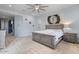 A stunning bedroom with a ceiling fan, neutral colors, and an abstract art piece over the bed at 2025 W Calle Del Sol --, Phoenix, AZ 85085