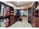 Spacious walk-in closet with custom shelving and drawers, offering ample storage space at 2025 W Calle Del Sol --, Phoenix, AZ 85085