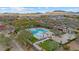 Aerial view of community pool with lounge seating, picnic areas, and playground in desert community at 2025 W Calle Del Sol --, Phoenix, AZ 85085