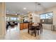 Open floor plan connects dining area and living room, with natural light from large windows at 2025 W Calle Del Sol --, Phoenix, AZ 85085