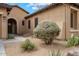 Close-up of the landscaped front yard and facade with arched entryway at 2025 W Calle Del Sol --, Phoenix, AZ 85085