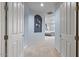 Hallway with neutral paint and carpet leading to a bedroom suite with a ceiling fan at 2025 W Calle Del Sol --, Phoenix, AZ 85085