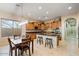 Modern kitchen with center island, pendant lighting, stainless appliances, and adjacent dining area at 2025 W Calle Del Sol --, Phoenix, AZ 85085