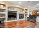 Comfortable living room with fireplace and built-in shelving, perfect for relaxation at 2025 W Calle Del Sol --, Phoenix, AZ 85085