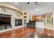 Cozy living room features a fireplace, built-in shelving, and hardwood floors at 2025 W Calle Del Sol --, Phoenix, AZ 85085