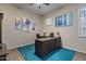 Spacious home office with a large desk, blue accent rug, and modern wall art at 2025 W Calle Del Sol --, Phoenix, AZ 85085