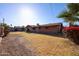 Backyard featuring a large patch of dry grass and a few plants at 2144 W Joan De Arc Ave, Phoenix, AZ 85029