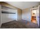 Bedroom featuring carpet flooring, closet, and view to the bathroom at 2144 W Joan De Arc Ave, Phoenix, AZ 85029