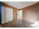 Bedroom featuring neutral carpet, closet doors and a doorway to another room at 2144 W Joan De Arc Ave, Phoenix, AZ 85029