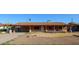 Single-story home featuring a covered front porch, carport, and fresh landscaping at 2144 W Joan De Arc Ave, Phoenix, AZ 85029