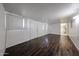 Living room with wood-look flooring, features a door and window with blinds at 2144 W Joan De Arc Ave, Phoenix, AZ 85029