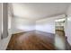 Bright living room featuring wood-look flooring, a window, and neutral paint at 2144 W Joan De Arc Ave, Phoenix, AZ 85029