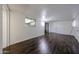 Bright living room with wood-look floors, leading to a sliding glass door at 2144 W Joan De Arc Ave, Phoenix, AZ 85029