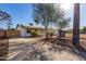 A lovely single-story house boasts a large driveway and beautiful desert landscaping, enhanced by a mature tree at 2205 N 22Nd St, Phoenix, AZ 85006