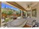 Covered back patio with an outdoor table, chairs, and ceiling fan at 22503 N 76Th Pl, Scottsdale, AZ 85255