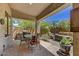 The covered patio features an outdoor kitchen, seating area, and view of the backyard at 22503 N 76Th Pl, Scottsdale, AZ 85255
