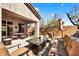 Back patio with outdoor furniture, a fire pit, desert landscaping, and a covered patio at 22503 N 76Th Pl, Scottsdale, AZ 85255