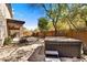 Back yard featuring a spa, pavers, desert landscaping, privacy fence, and a covered patio at 22503 N 76Th Pl, Scottsdale, AZ 85255