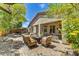 Outdoor seating area with a built-in BBQ and patio area with lush desert landscaping at 22503 N 76Th Pl, Scottsdale, AZ 85255