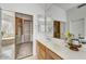 Bathroom with double vanity, large mirror, and walk-in closet at 22503 N 76Th Pl, Scottsdale, AZ 85255