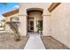 Inviting front entrance with stone pathway, potted plant, security door and arched porch at 22503 N 76Th Pl, Scottsdale, AZ 85255