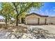 Charming home featuring desert landscaping, a spacious driveway, and a two-car garage at 22503 N 76Th Pl, Scottsdale, AZ 85255