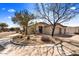 Charming single-story home featuring desert landscaping, a three car garage, and mature trees at 22503 N 76Th Pl, Scottsdale, AZ 85255