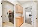 Bright laundry room with cabinetry, side by side washer and dryer, and tile flooring at 22503 N 76Th Pl, Scottsdale, AZ 85255