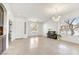 Open concept living room and entry way featuring light tile floors, chandelier, and abundant light at 22503 N 76Th Pl, Scottsdale, AZ 85255