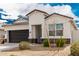 Charming single-story home featuring a dark grey two-car garage and minimal desert landscaping at 24029 W Zak Rd, Buckeye, AZ 85326