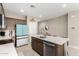 Kitchen island offers a stainless steel sink and a dishwasher for easy cleanup at 24029 W Zak Rd, Buckeye, AZ 85326