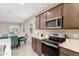 Well-lit kitchen features modern appliances and a view of the living area at 24029 W Zak Rd, Buckeye, AZ 85326