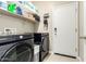 Laundry room with modern machines, shelving, and access to the exterior at 24029 W Zak Rd, Buckeye, AZ 85326