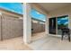 Covered patio features sturdy columns, a sliding door, and backyard access at 24029 W Zak Rd, Buckeye, AZ 85326